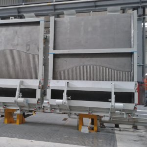 APS noise-barrier moulds on a turning device after the demoulding phase, in an automated precast plant.